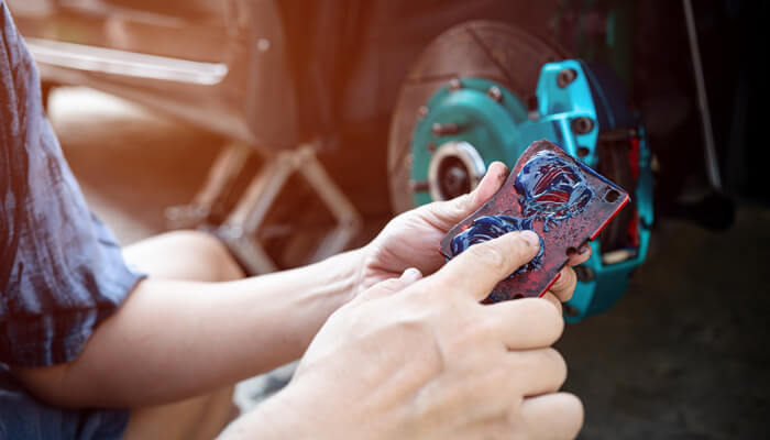 Heavy-Duty grease being applied to brake pad