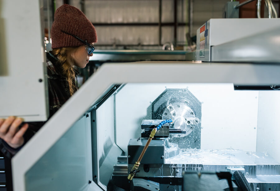 Metalwork operator working with CNC cooling fluids